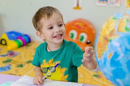 Joyful Child Engaging with a Globe